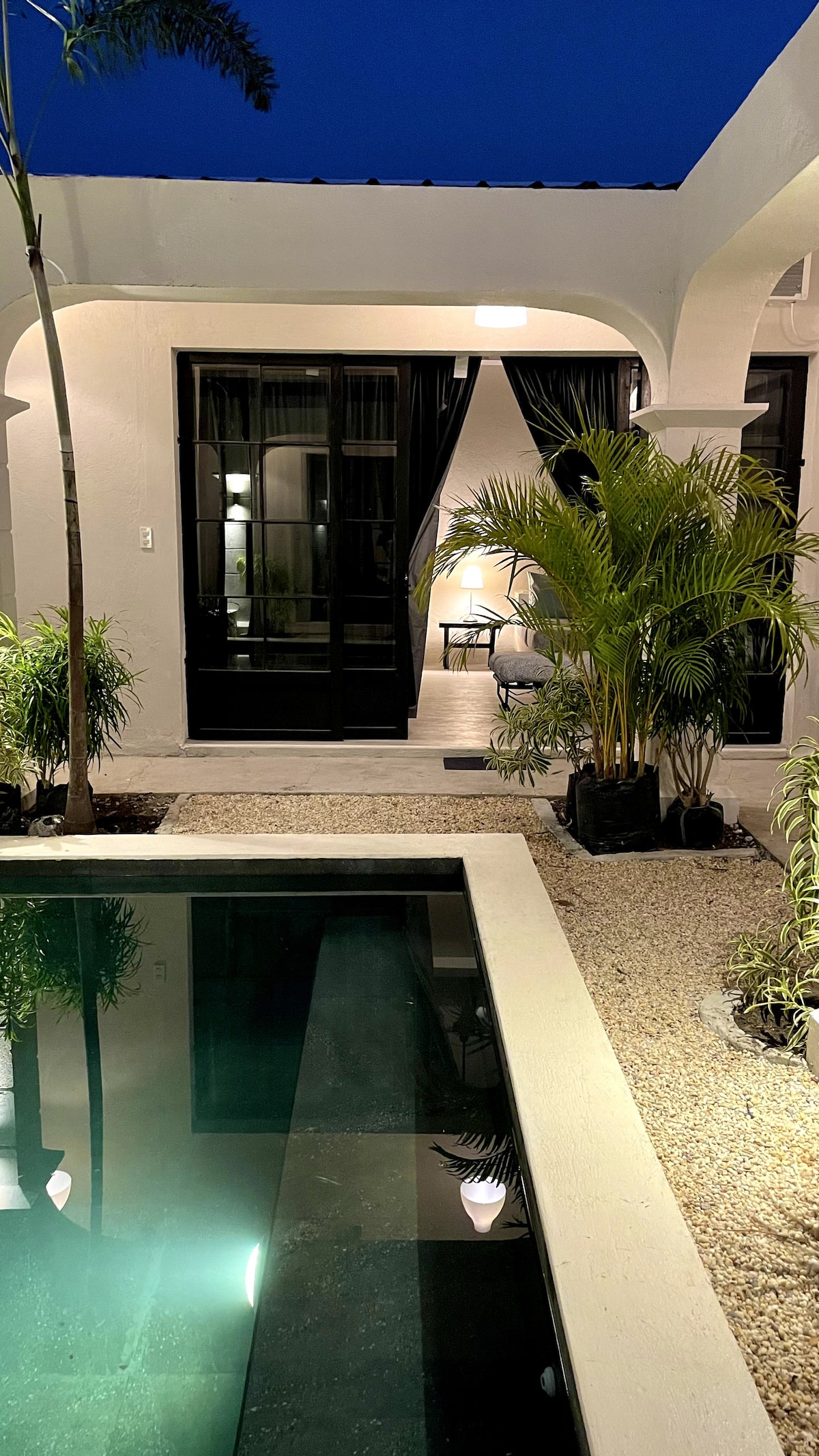 Casa Dos pool at night with tropical garden