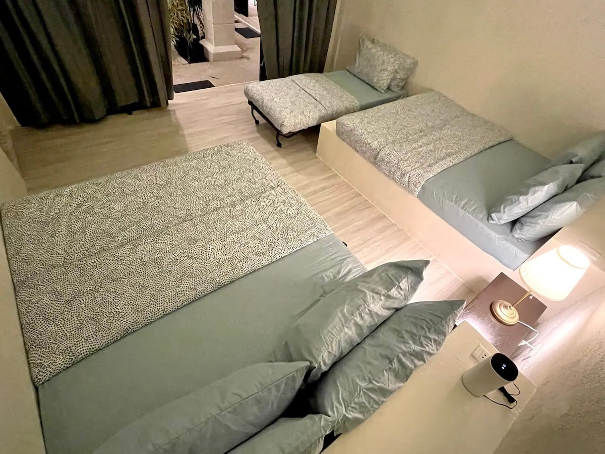 Casa Dos bedroom with sage blue linens